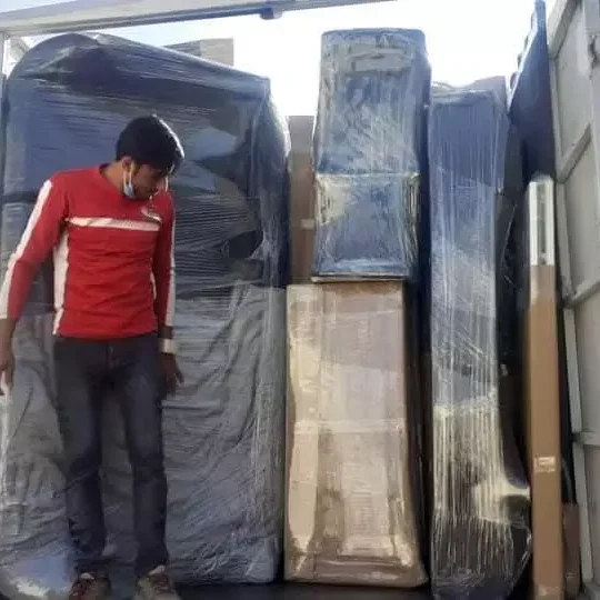 Movers loading furniture safely into a moving truck